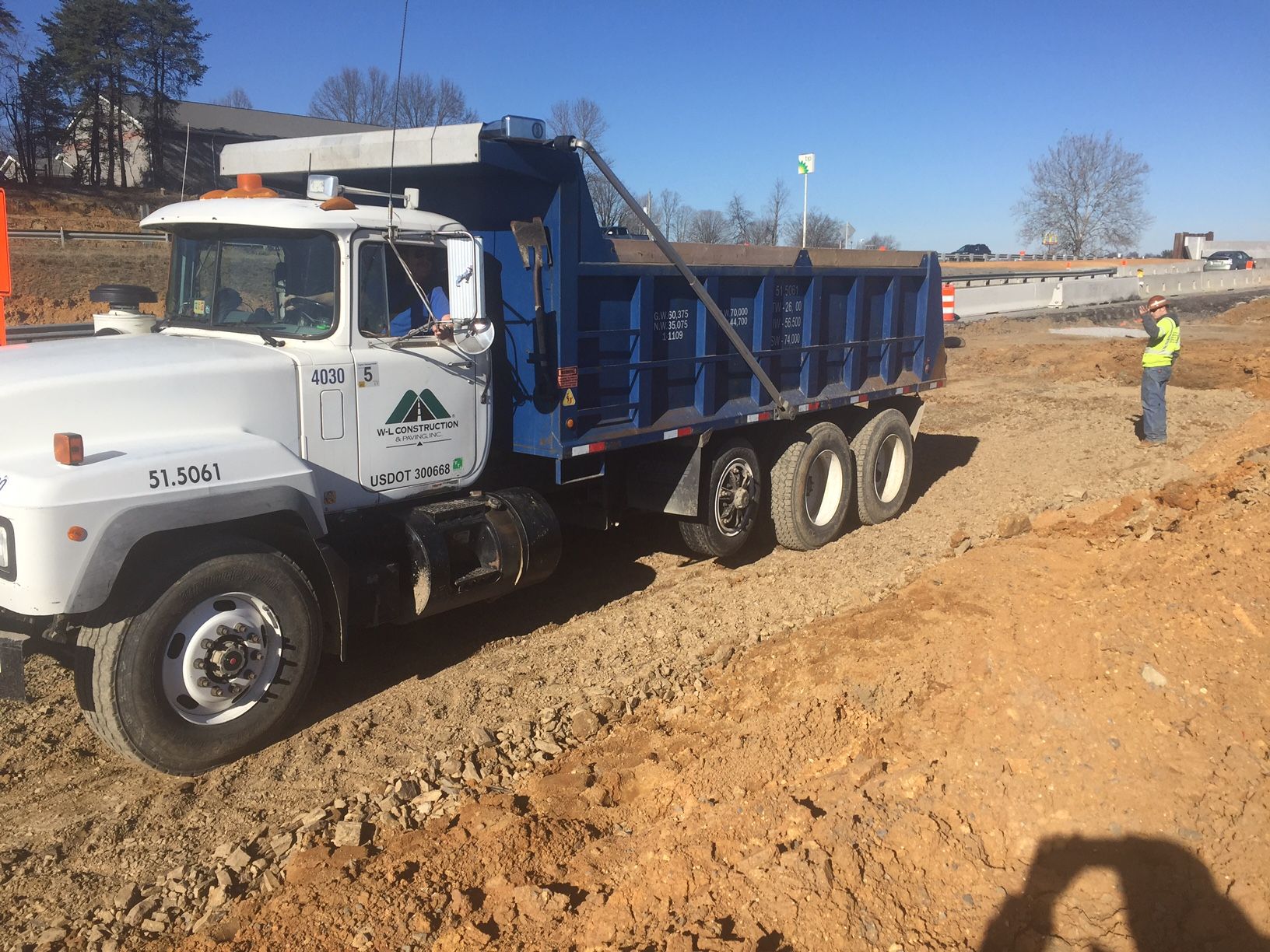 W-L dump truck on a graded commercial site
